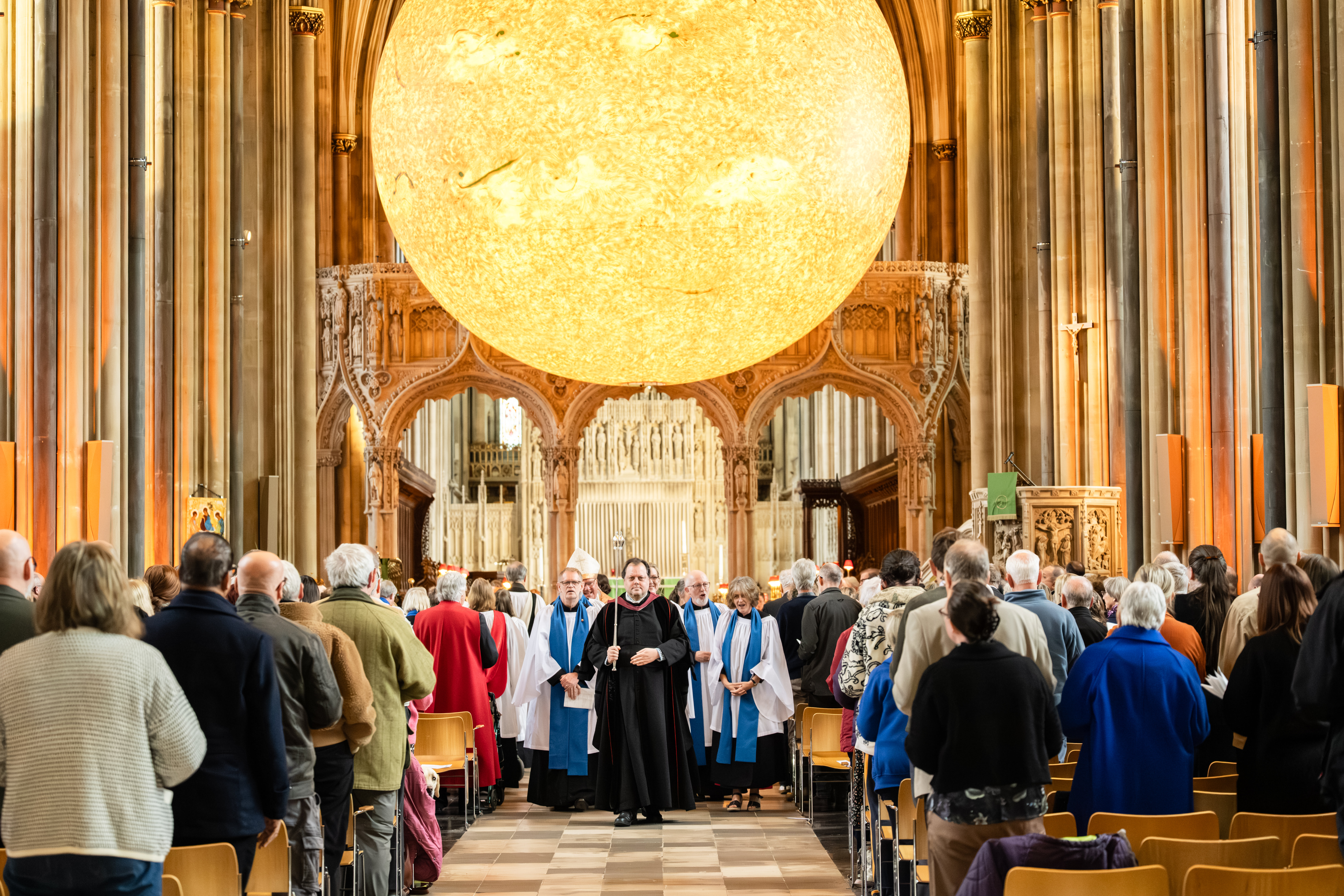 The procession leaving the Cathedral with the Helios sculpture in the background