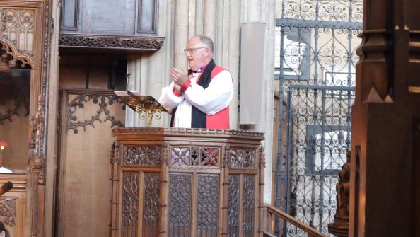 Bishop Neil applauds musicians.png