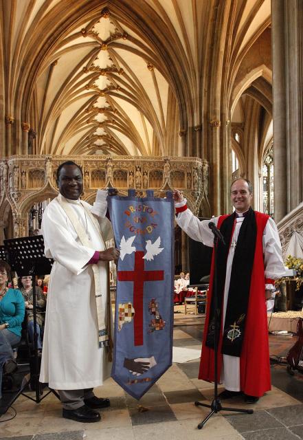 Bishop Paul Luzinda Kizito from Mukono receives a commemorative banner from Bishop Lee Rayfield, Swindon